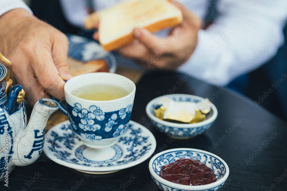 © LUMINA IMAGES - Hand of unrecognisable man holding a cup of tea. © LUMINA IMAGES - Hand of unrecognisable man holding a cup of tea.