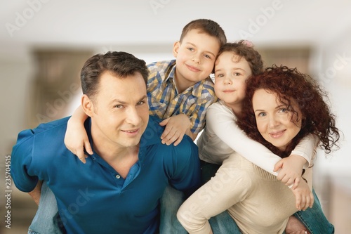 Beautiful smiling family sitting at sofa © BillionPhotos.com