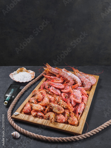 Frozen raw tiger royal shrimps on the wooden board