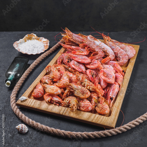 Frozen raw tiger royal shrimps on the wooden board
