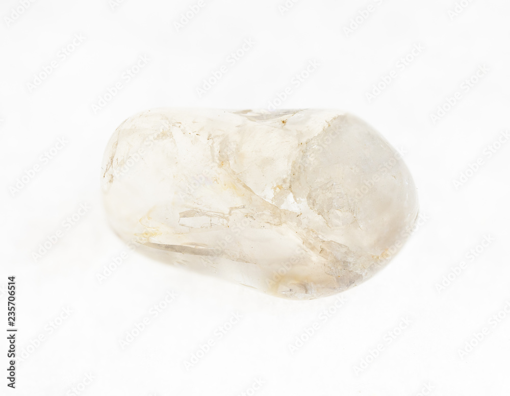 tumbled rock crystal ( quartz) gemstone on white