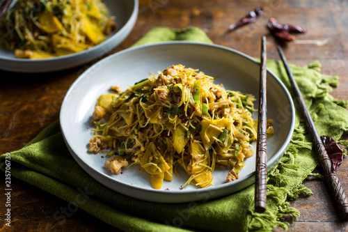 Stir fried rice vermicelli with beet and beet green served on plate