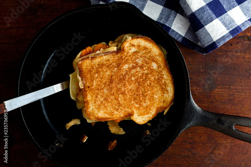 Overhead view of potato grilled cheese sandwich in frying pan photo