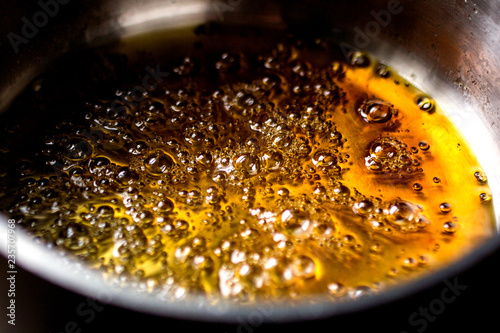 Close of caramel boiling in pan