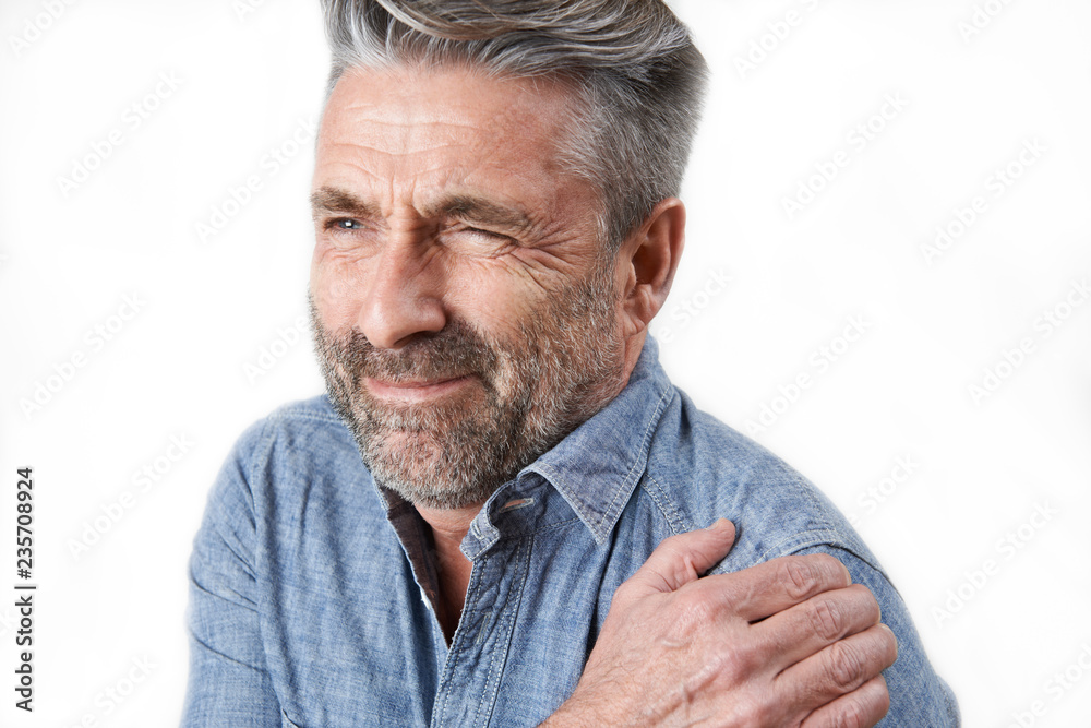 Studio Shot Of Man Suffering With Frozen Shoulder Studio Shot Of Man Suffering With Frozen Shoulder