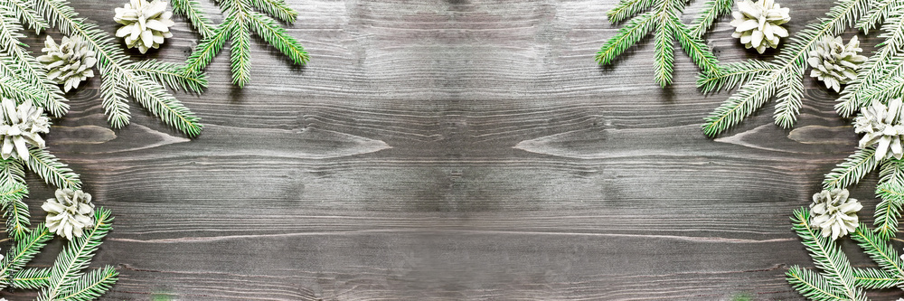Christmas background with fir tree and decoration on dark wooden board Christmas background with fir tree and decoration on dark wooden board