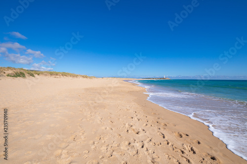 beautiful and idyllic landscape of wild natural long beaches of Zahora and Cala Isabel, near Canos Meca village (Barbate, Cadiz, Andalusia, Spain) and Cape Trafalgar with lighthouse