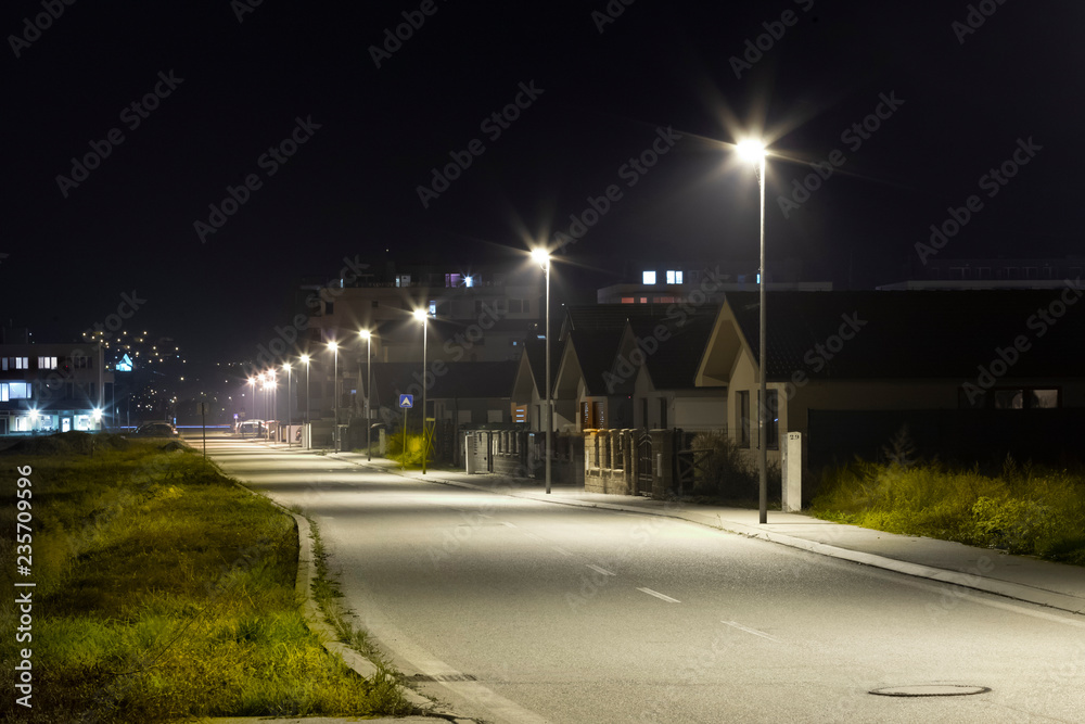 village street with modern LED streetlights at night