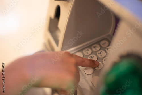 Woman is close up of hand, finger pressing keystroke cash machine, ATM banking Located in front of the bank.