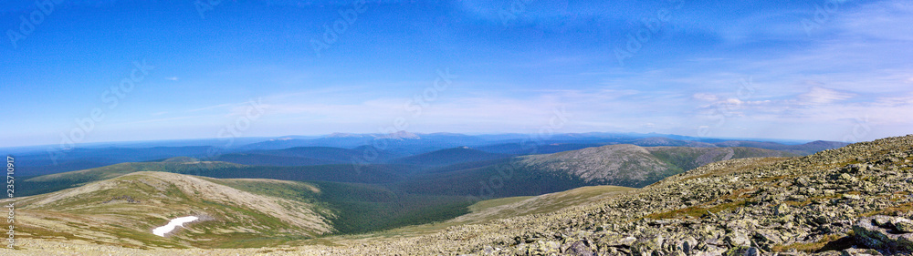 Beautiful summer landscape in good weather. Panorama of the Ural Mountains with huge boulders on the hillsides.