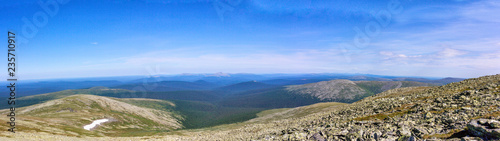 Beautiful summer landscape in good weather. Panorama of the Ural Mountains with huge boulders on the hillsides.