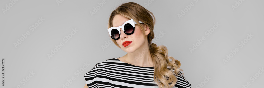 Fototapeta premium Young girl with glasses hands on waist