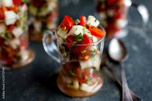 Close up of watermelon and tomato salsa served in cup photo