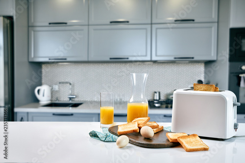 Continental breakfast - orange juice and toast on white table.