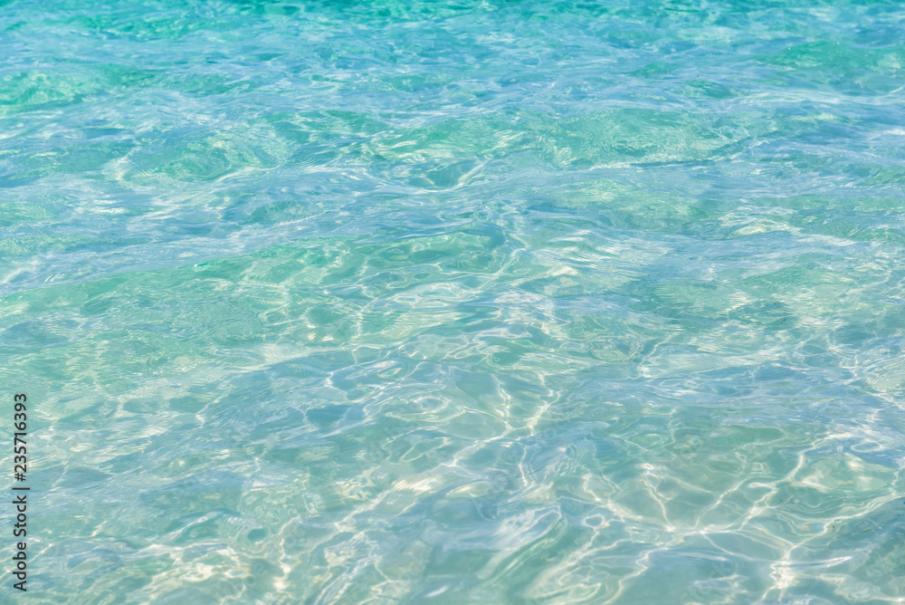 crystal clear sea water at tropical beach,reflections on surface of water