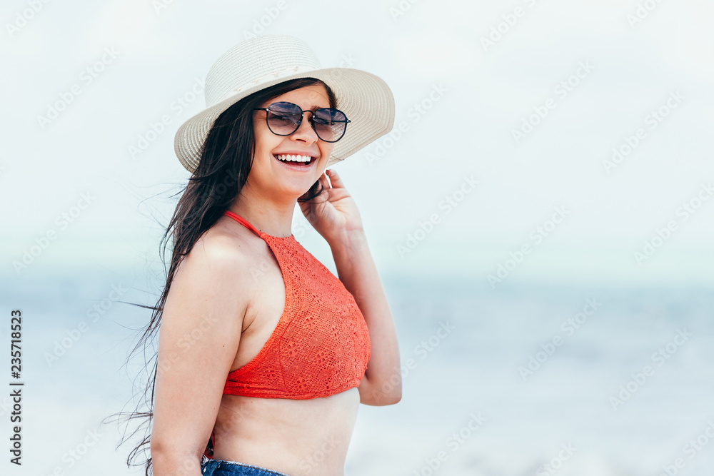 Woman in the beach. Portrait of woman in bikini and sunglasses
