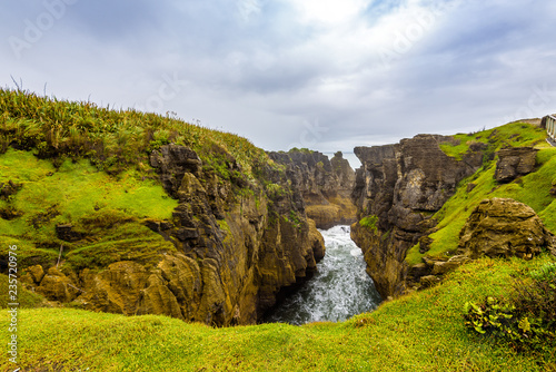 Sea and natural layered rock formations from erosion. Pancake Rocks and Blowholes, Paparoa National Park, West Coast, near Hokitika, New Zealand. photo