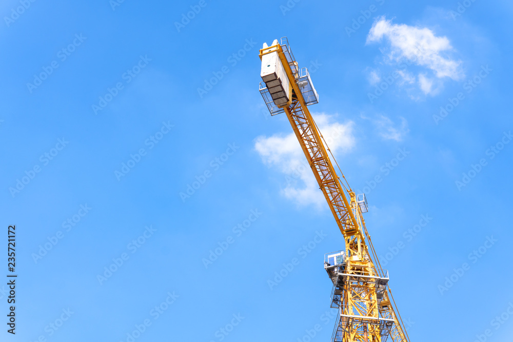 Construction industry of Engineer Business, Technology Concept with Industrial yellow cranes with blue sky ,clouds background on site building from high ground and heavy material. Construction industry of Engineer Business, Technology Concept with Industrial yellow cranes with blue sky ,clouds background on site building from high ground and heavy material.