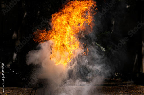 Flames caused by the explosion of the oil. Demonstration of water on oil fire.