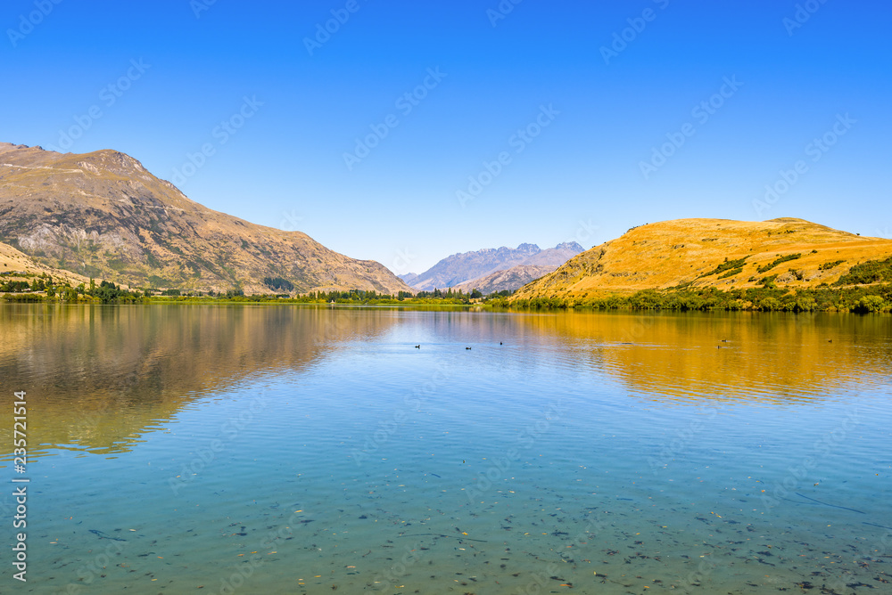 Peaceful and calm scene, relaxing hilly and lake landscape. Lake Hayes, Queenstown, New Zealand.