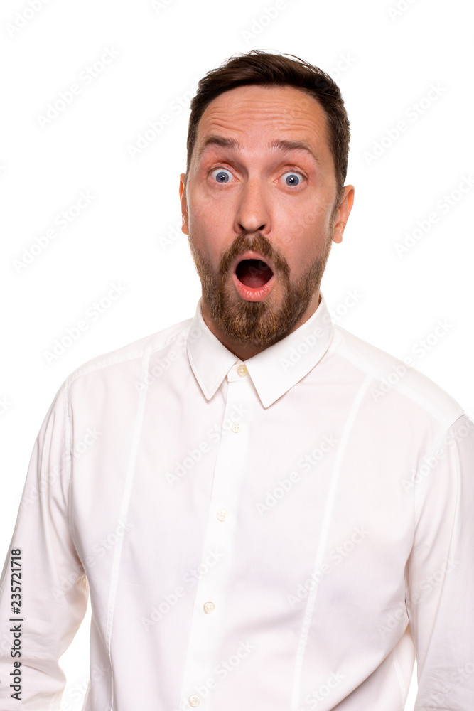 Unbelievable news. Young adult crazy man with opened mouth looking at camera. Studio shot, white background Unbelievable news. Young adult crazy man with opened mouth looking at camera. Studio shot, white background