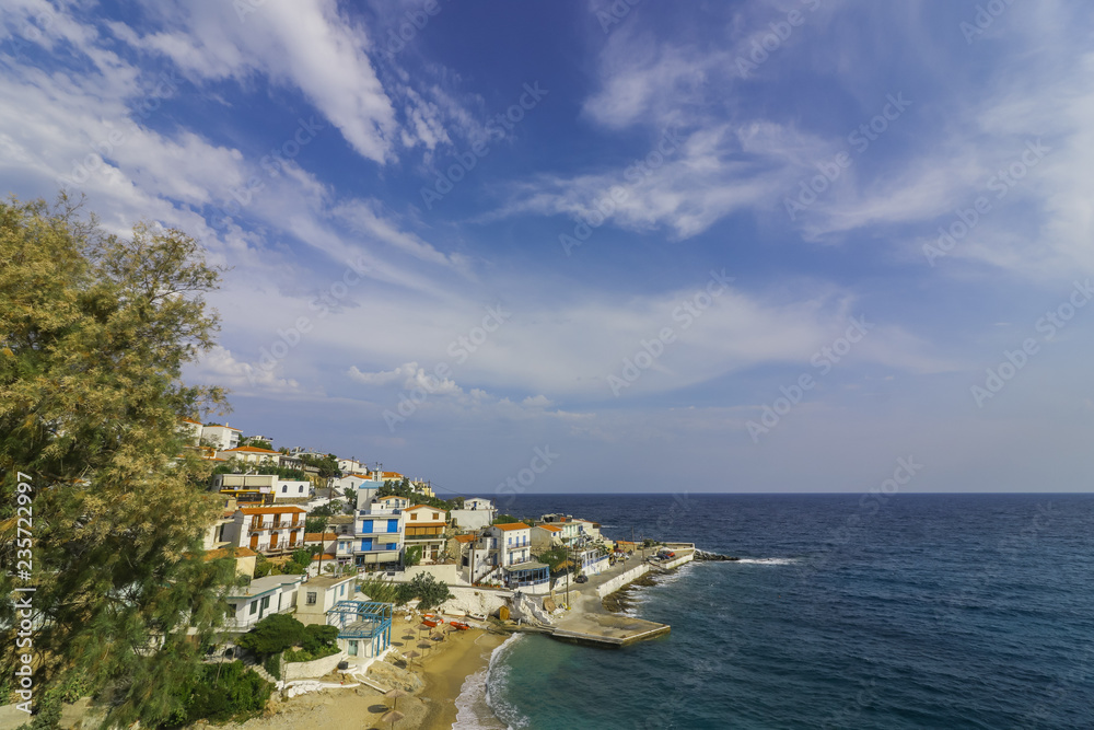 beautiful fishing village with traditional greek  houses and romantic harbor in the popular holiday destination Armenistis, Ikaria, Greece