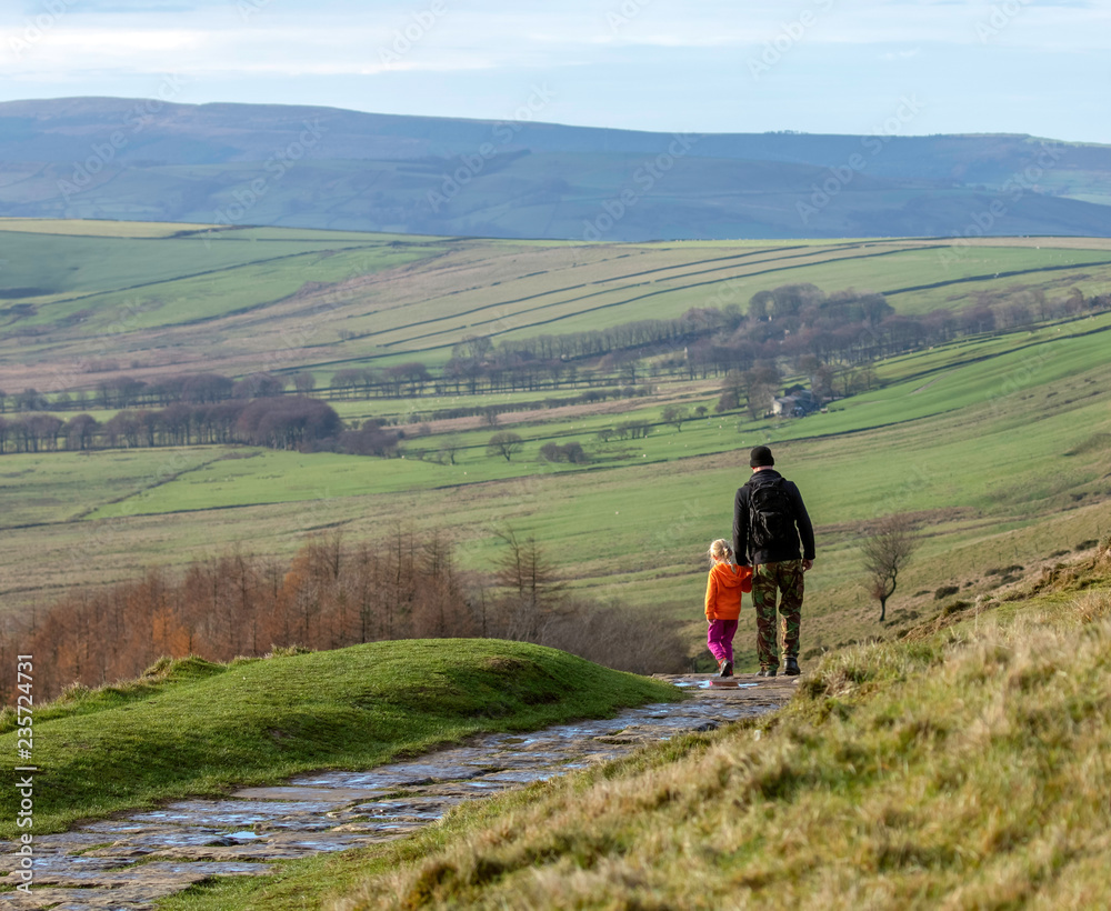FATHER AND DAUGHTER WALKING IN THE UK COUNTRYSIDE
