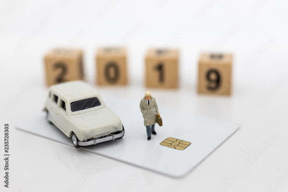 Fototapeta premium Miniature people: Businessman standing front of wood block 2019. Image use for business concept and happy new year.