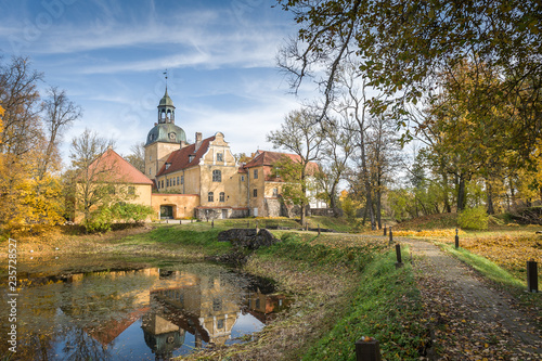 View of Lielstraupe Castle on a sunny autumn day.  Latvia, Baltic. One of the medieval castles of Latvia that has survived till nowadays and united in one corps with the church. photo