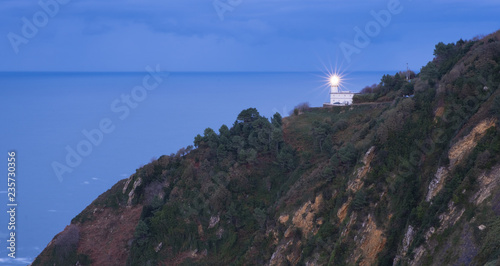 Light in the lighthouse of Mount Igueldo with the sea in the background, city of Donostia, Euskadi
