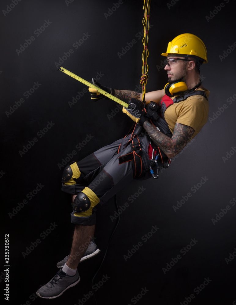 stylish climber Builder hands and works with the tool. black background. copy past