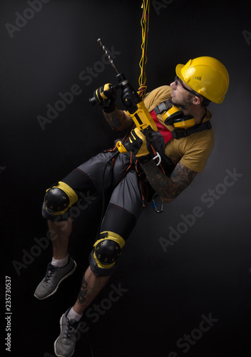 stylish climber Builder hands and works with the tool. black background. copy past