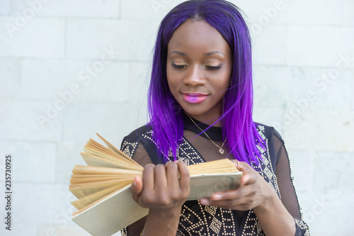 A girl is reading a book. W...