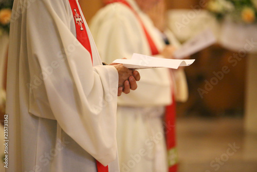 Canvastavla priest with hands joined in prayer during Holy Mass in church