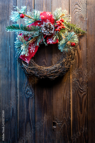 Christmas wreath on a rustic wooden door.