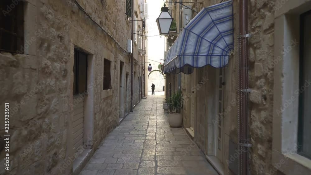 Handheld tracking shot a rustic narrow alleyway in Dubrovnik Handheld tracking shot a rustic narrow alleyway in Dubrovnik