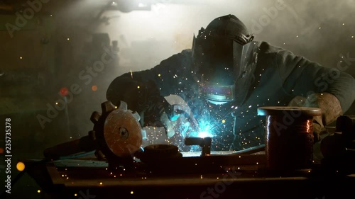 Super slow motion of working welder in workshop, filmed on high speed cinema camera, 1000 fps. photo
