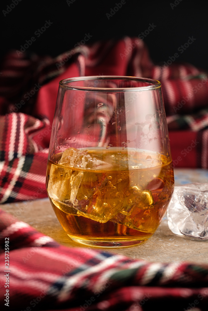 Still-life with a glass of bourbon. A glass of whiskey with ice. Concept of autumn spleen Still-life with a glass of bourbon. A glass of whiskey with ice. Concept of autumn spleen