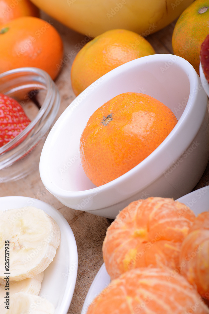 Close-up shot of variety of fruits on old wooden plate Close-up shot of variety of fruits on old wooden plate
