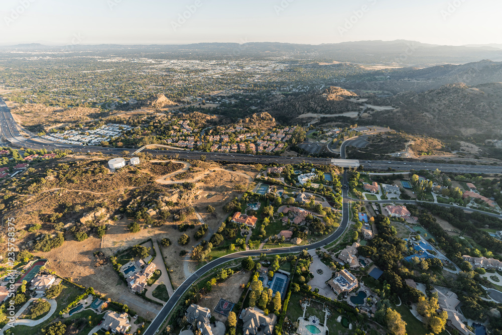 Late afternoon aerial view of homes, estates, mansions and the 118 freeway in the Chatsworth neighborhood of Los Angeles, California.