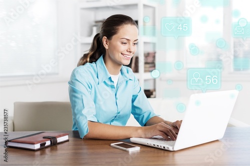 Young attractive businesswoman working with laptop
