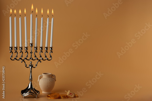 Glowing flame of burning candles on menorah candlestick for celebration of Jewish holiday Hanukkah photo