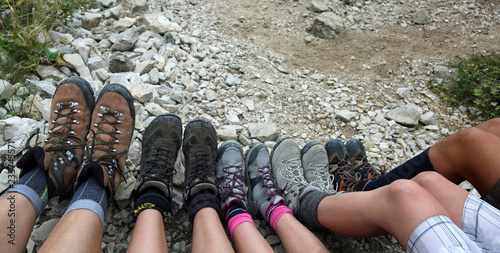 Mountain boots of the five-person family rests after the hike on