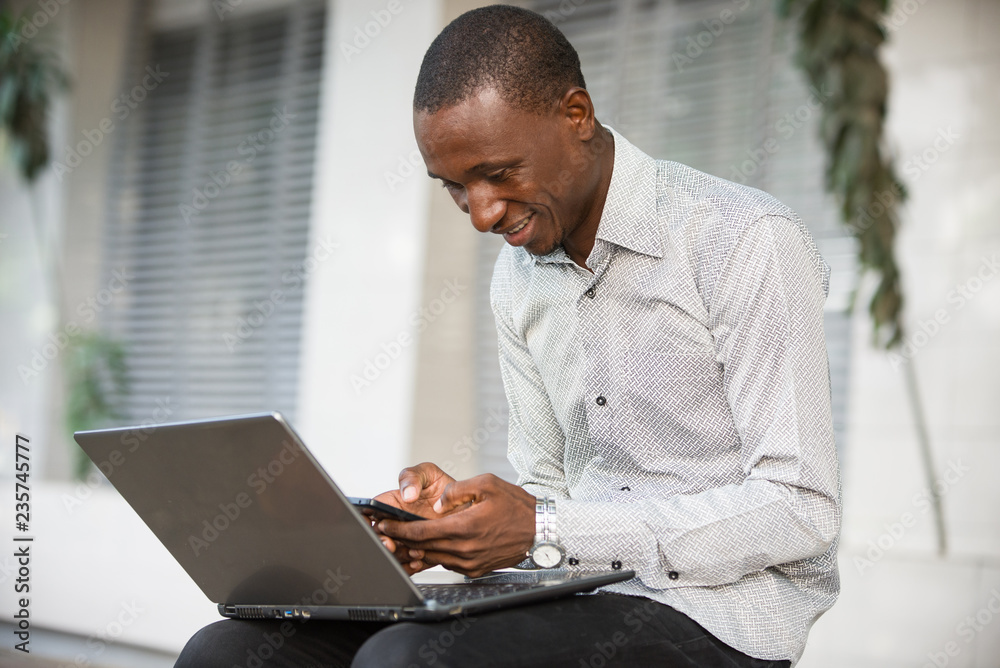 portrait of young man with mobile phone, smiling. portrait of young man with mobile phone, smiling.