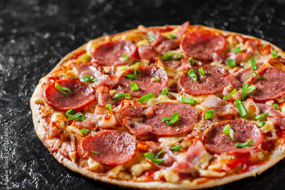 Pepperoni Pizza with Mozzarella cheese, salami, bacon, Tomato sauce, pepper, Spices and Fresh green onion. Italian pizza on black background Pepperoni Pizza with Mozzarella cheese, salami, bacon, Tomato sauce, pepper, Spices and Fresh green onion. Italian pizza on black background