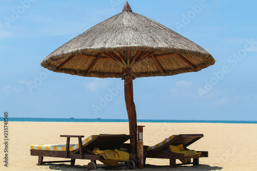 Fototapeta Naklejka Na Ścianę i Meble -  Beach chairs with umbrella and beautiful sand beach
