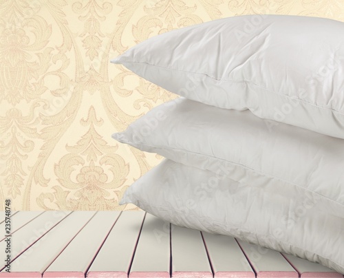 Fototapeta Naklejka Na Ścianę i Meble -  White Pillows Pile on wooden background