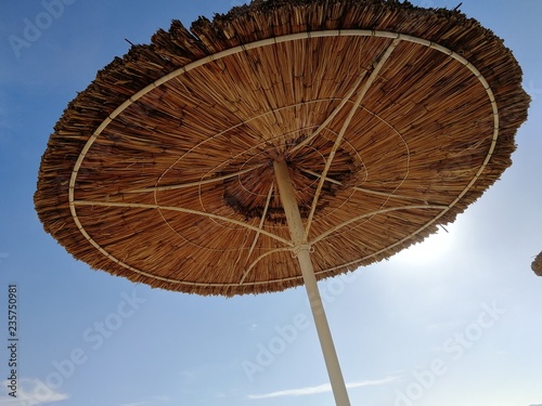 beach straw umbrella against the sky. outdoor