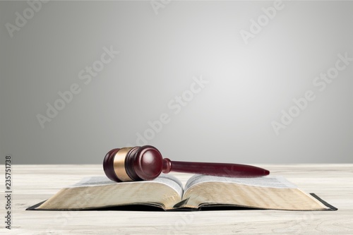 Woogen gavel on book on wooden table