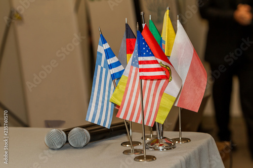 Many colorful national flags in a conference room - Business and communication vehicle concept. European pennants on the table of the conference hall according to the countries of the meeting